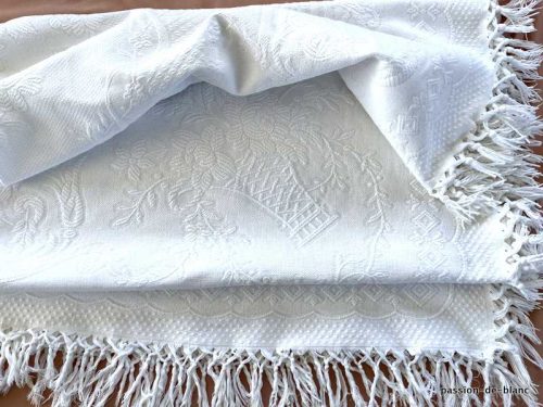 Linge ancien – Charmante couverture en coton avec paniers fleuris et franges en encadrement